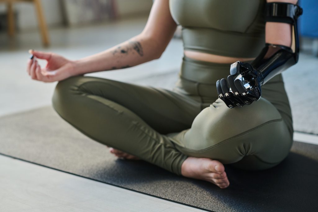 Advancements in Prosthetic Technology: Top 5 Prosthetic Hands on the Market woman sitting in lotus position and doing yoga