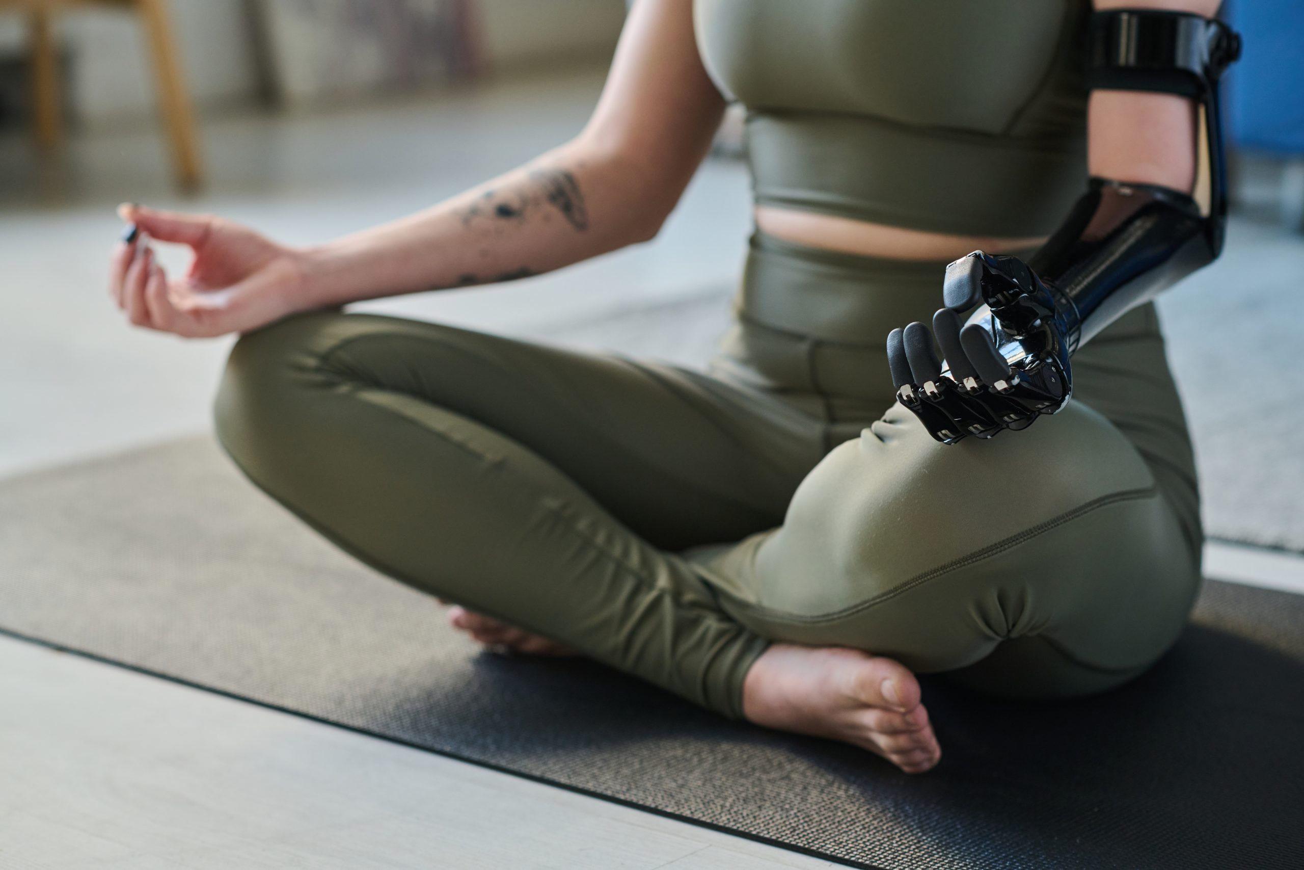 Advancements in Prosthetic Technology: Top 5 Prosthetic Hands on the Market woman sitting in lotus position and doing yoga